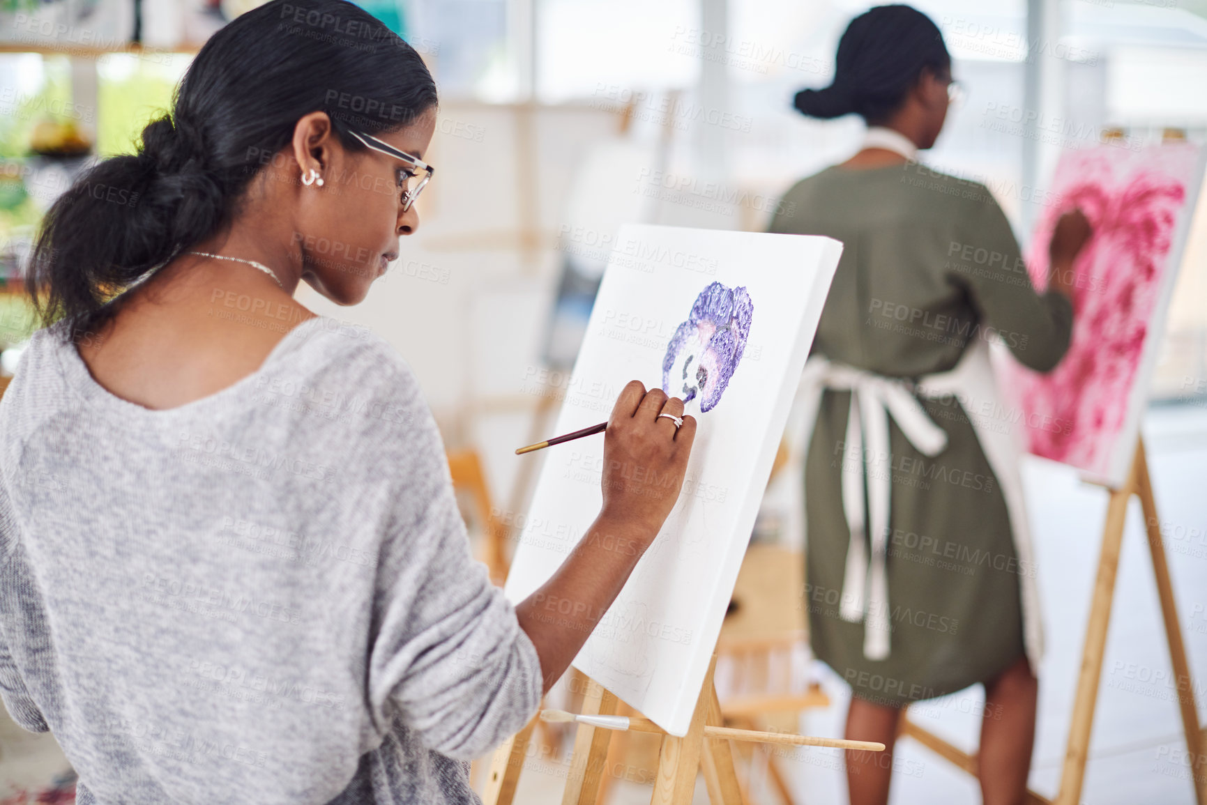 Buy stock photo Cropped shot of a beautiful young woman painting in a art studio