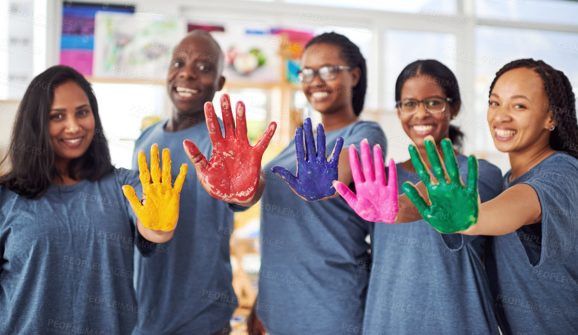 Buy stock photo Cropped shot of a group of people posing with paint on their hands