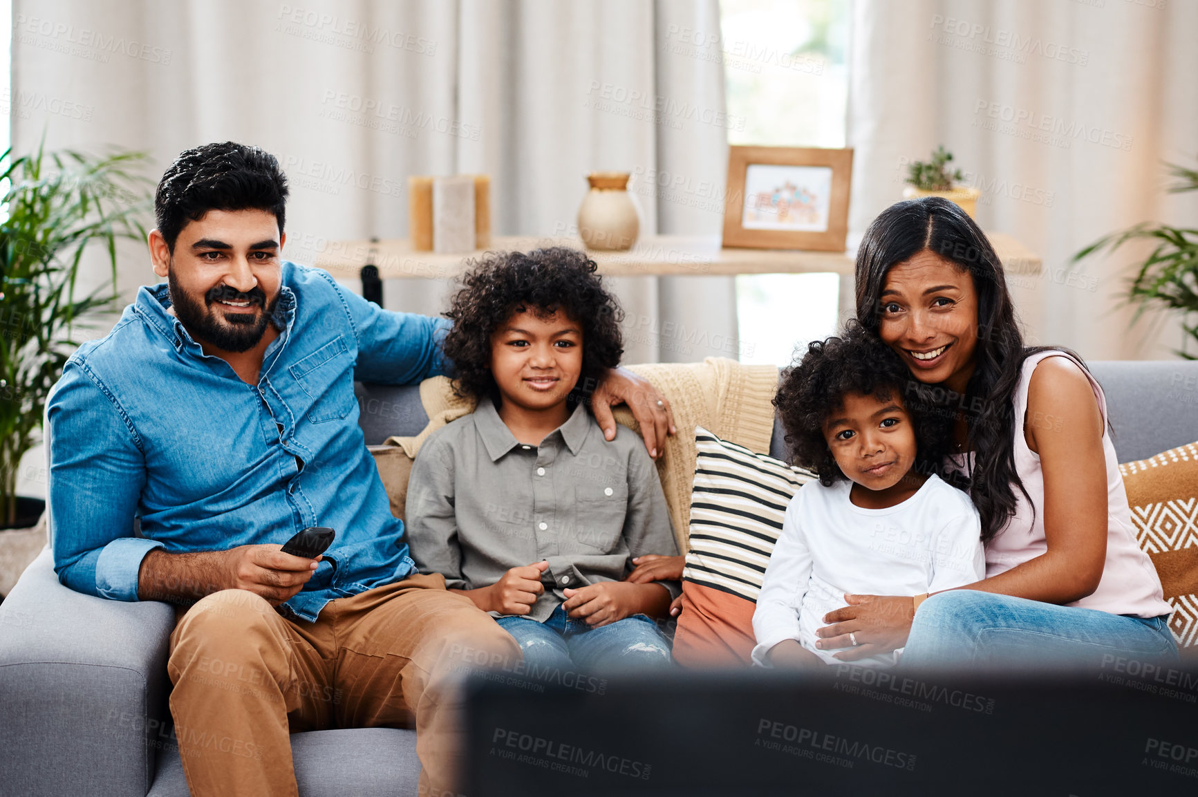 Buy stock photo Dad, mom and children in living room watching tv on sofa with family, bonding together and smile. Weekend, relax and kids on couch streaming movie or television show with subscription in Spain.