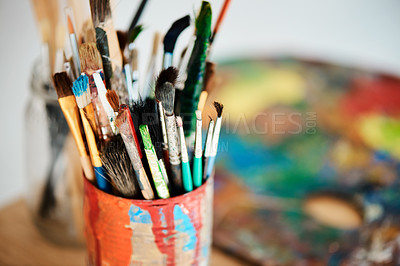 Buy stock photo Creative, art and container with paintbrush on table for colorful craft, design and tools in jar. Container, palette and workshop with equipment for artistic project, painting and hobby on desk