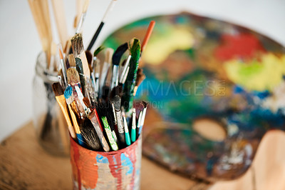 Buy stock photo Cropped shot of a tin full of paintbrushes in an empty art studio after a painting class