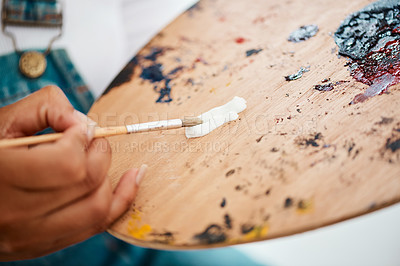 Buy stock photo Cropped shot of an unrecognizable artist dipping her paintbrush into white paint during an art session in a studio