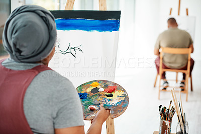 Buy stock photo Cropped shot of two unrecognizable artists sitting and painting on a canvas during a painting session in an art studio
