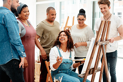 Buy stock photo Cropped shot of an attractive young woman sitting and explaining her artwork to her friends during an art class