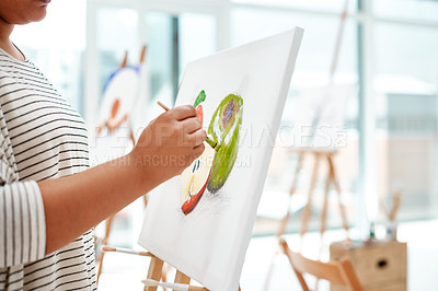 Buy stock photo Cropped shot of an unrecognizable artist standing and painting on a canvas during a painting session in an art studio