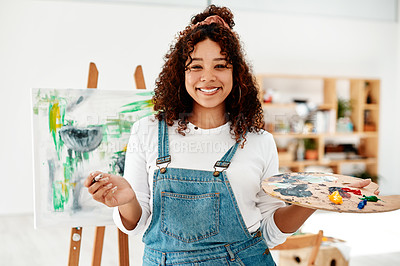 Buy stock photo Cropped portrait of an attractive young artist standing alone in the studio and holding a palette during an art class