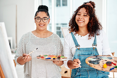 Buy stock photo Cropped portrait of two attractive artists standing together during an art class in the studio