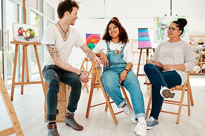 Buy stock photo Cropped shot of a diverse group of friends sitting together and talking during an art class in the studio