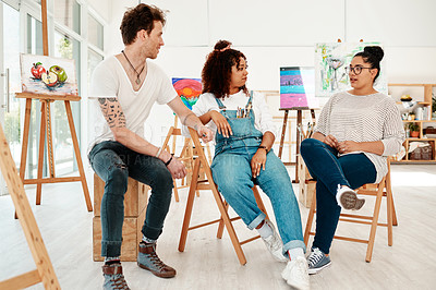 Buy stock photo Cropped shot of a diverse group of friends sitting together and talking during an art class in the studio