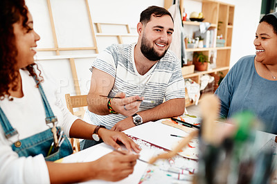 Buy stock photo Cropped portrait of a diverse group of artists sitting together and painting during an art class in a studio