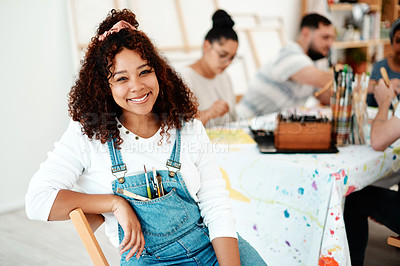 Buy stock photo Cropped portrait of an attractive young woman sitting with her friends during an art class in the studio