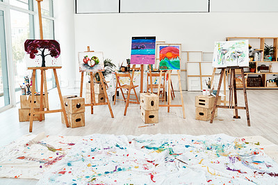 Buy stock photo Cropped shot of painted canvas on easels in an empty studio after an art class during the day
