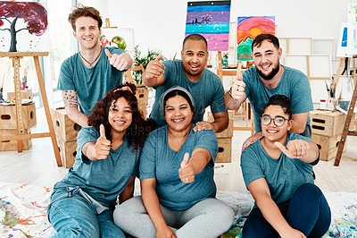 Buy stock photo Cropped portrait of a diverse group of friends posing together and showing a thumbs up after an art class