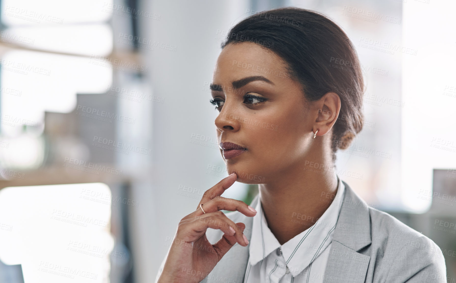 Buy stock photo Cropped shot of an attractive young businesswoman looking thoughtful while working inside her office