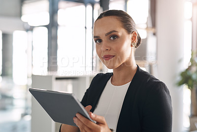 Buy stock photo Portrait of an attractive young businesswoman using a digital tablet inside her office