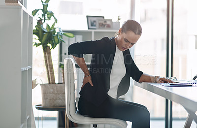 Buy stock photo Frustrated woman, back pain and injury with posture for muscle tension or spine inflammation at office desk. Female person, worker or business employee with sore bruise, ache or sprain at workplace