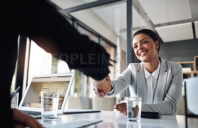 Buy stock photo Cropped shot of an attractive young businesswoman shaking hands with a colleague inside an office