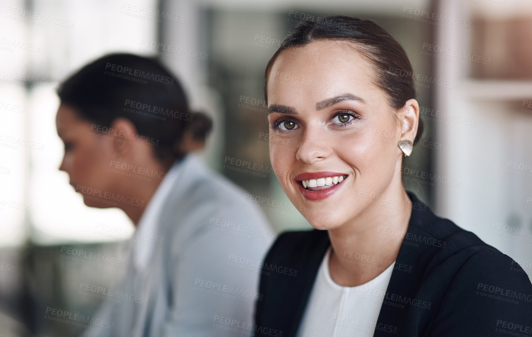 Buy stock photo Portrait of an attractive young businesswoman posing inside an office with her colleague in the background