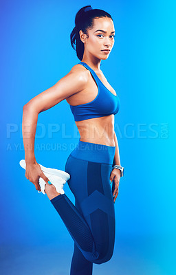 Buy stock photo Fitness, stretching legs and portrait of woman on blue background for health, wellness and warm up in studio. Personal trainer, yoga and isolated person for exercise, training and workout for gym