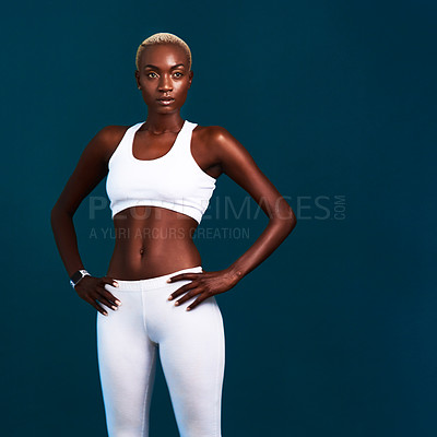 Buy stock photo Cropped shot of an attractive young sportswoman standing alone against a dark background in the studio