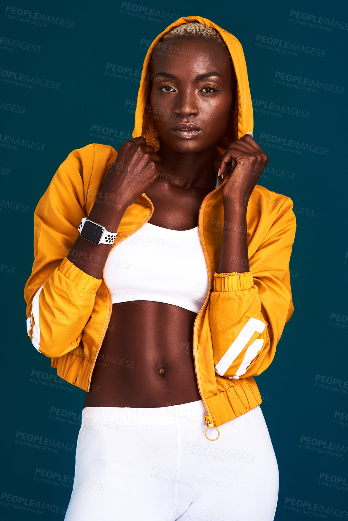 Buy stock photo Cropped portrait of an attractive young sportswoman standing alone and posing against a dark background in the studio