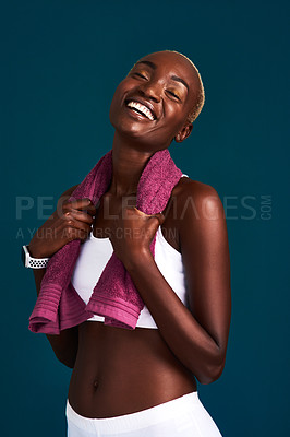 Buy stock photo Cropped shot of an attractive young sportswoman standing alone with a towel around her neck after a workout
