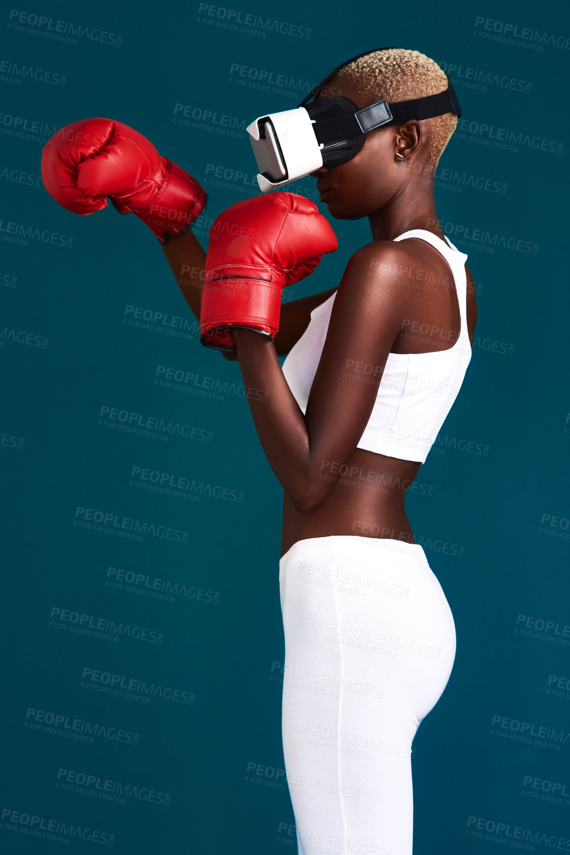 Buy stock photo Woman, vr and headset for boxing, sports and future innovation with esports, fight and gaming technology. Black person, goggles and virtual reality in studio on blue background for metaverse fitness