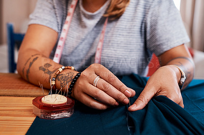 Buy stock photo Cropped shot of an unrecognizable woman making a garment at home