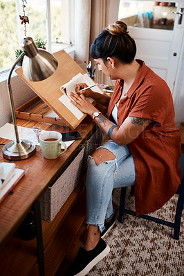 Buy stock photo Full length shot of a young woman sketching at home