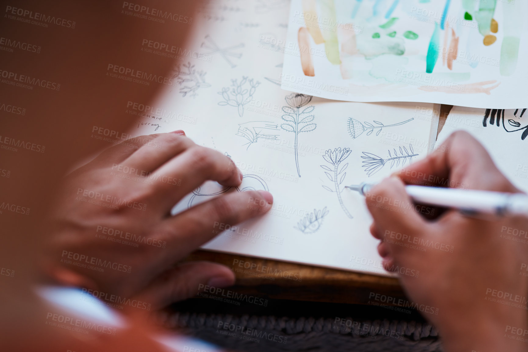 Buy stock photo Cropped shot of a young woman sketching at home