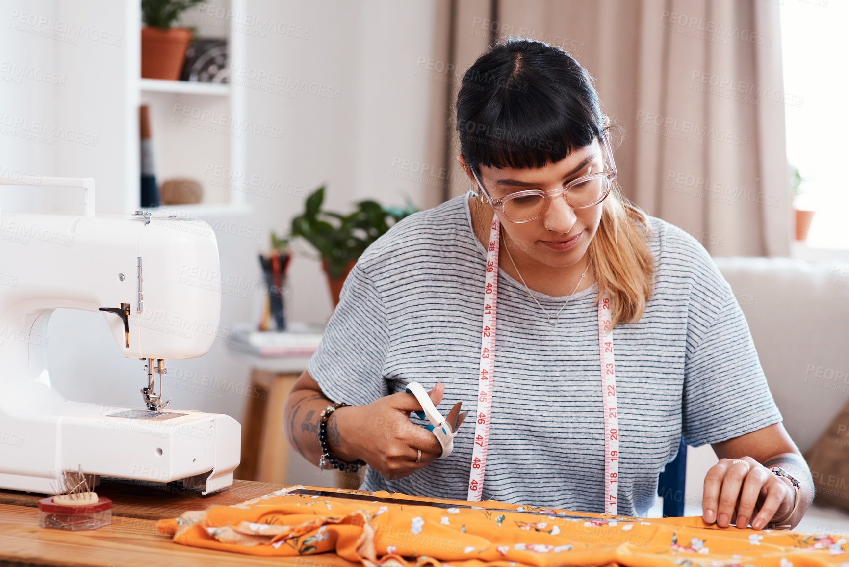 Buy stock photo Cropped shot of a young woman designing a garment at home