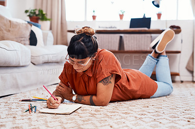 Buy stock photo Woman, art and drawing on floor for relax with inspiration and creative talent for project. Book, paper sketch and artist girl on apartment carpet with color pencils and design for tattoo business