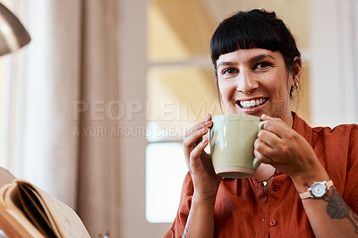 Buy stock photo Shot of an attractive young woman drinking coffee while relaxing at home