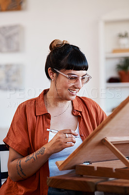 Buy stock photo Shot of an artist sketching in a desk easel at home