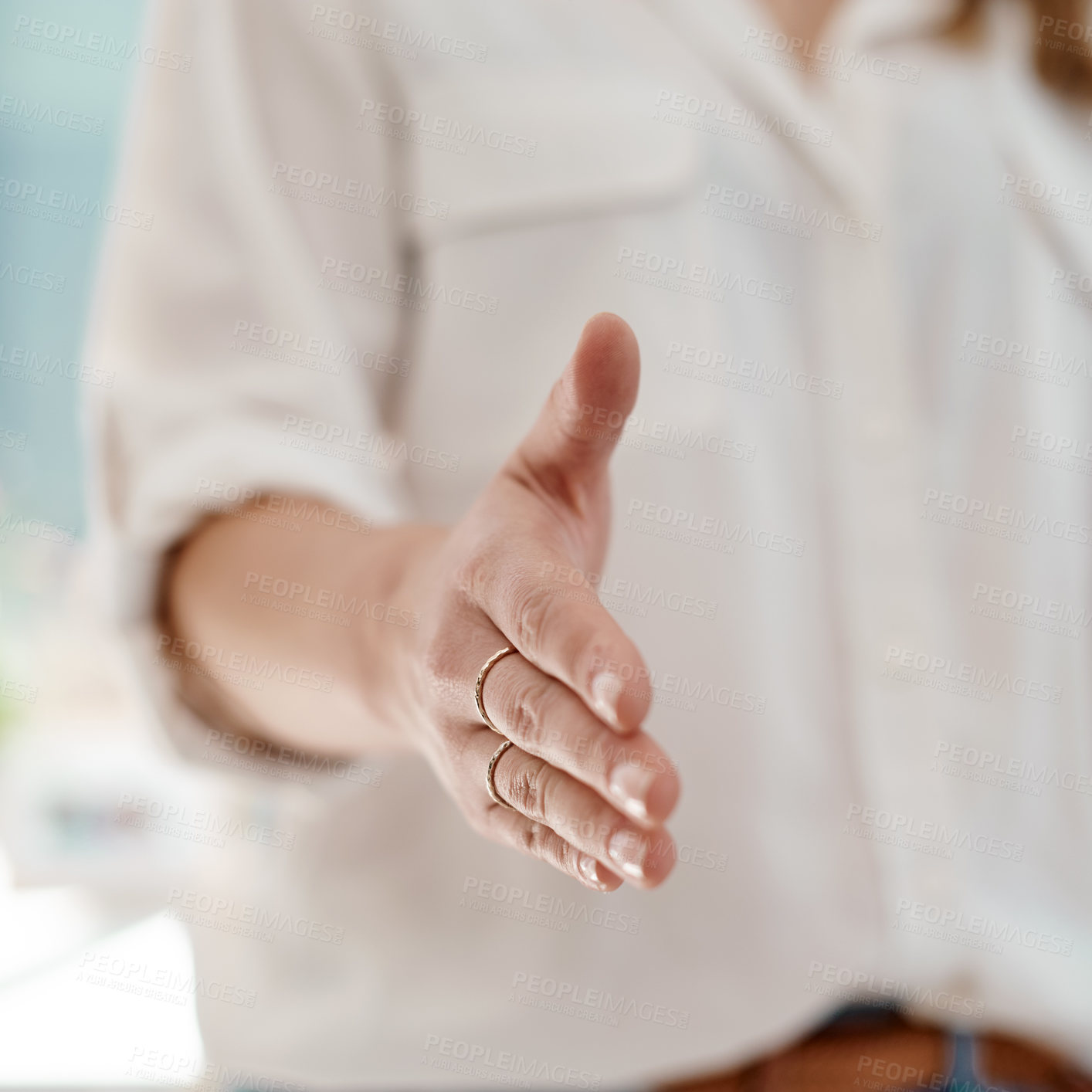 Buy stock photo Cropped shot of an unrecognizable businesswoman reaching out for a handshake inside her office