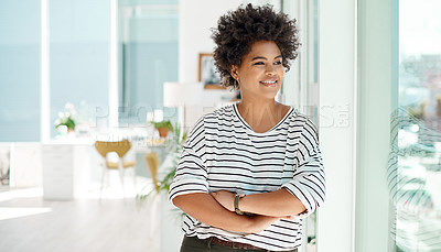 Buy stock photo Shot of a young businesswoman looking thoughtfully out the window in an office
