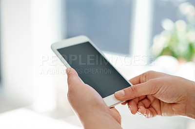 Buy stock photo Cropped shot of an unrecognizable businesswoman using her smartphone inside of an office
