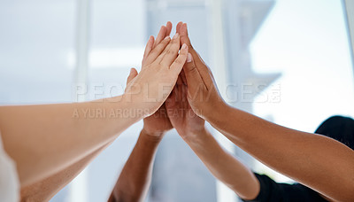 Buy stock photo Cropped shot of three unrecognizable businesswomen joining hands for a high five together inside an office