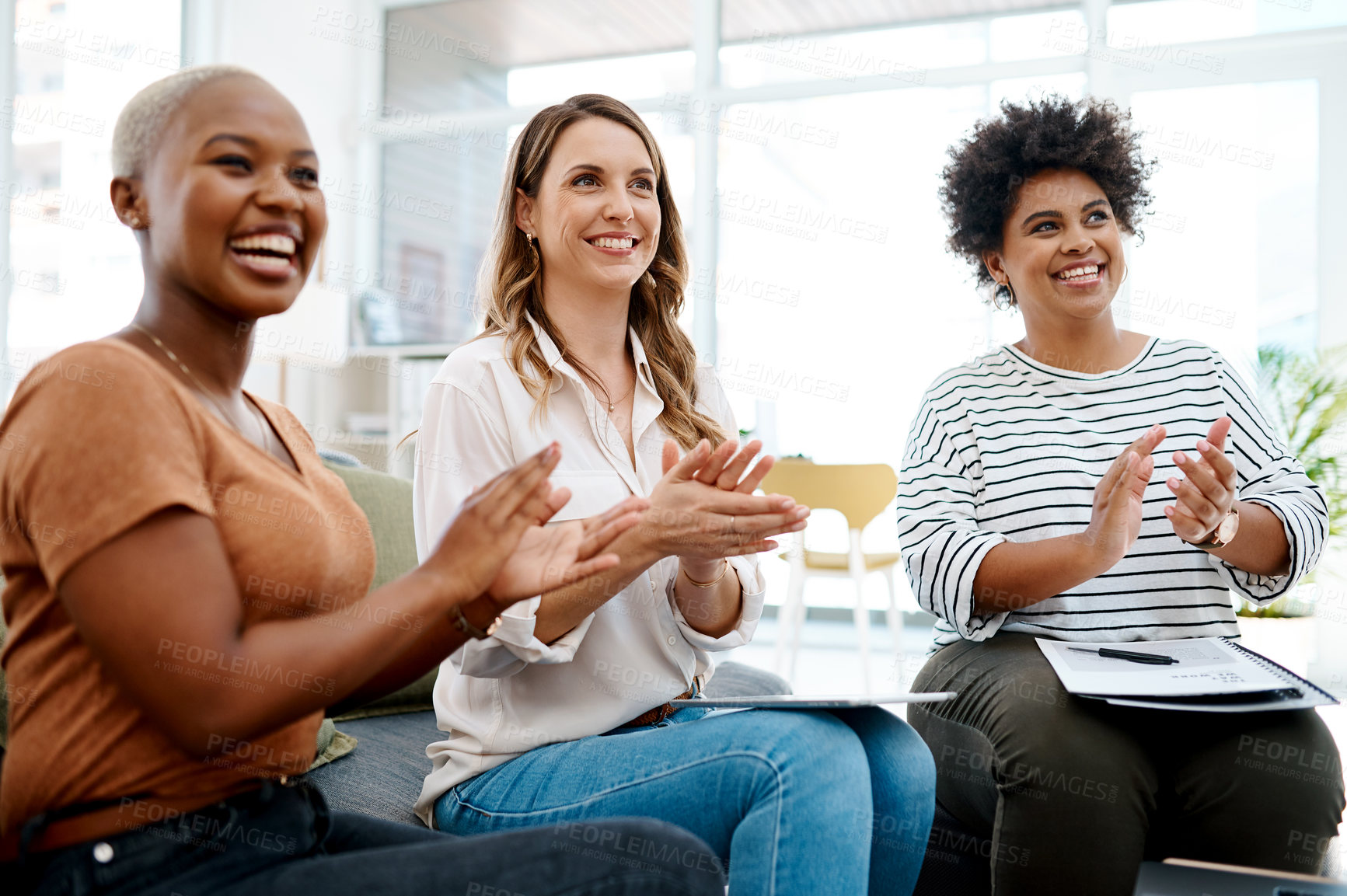 Buy stock photo Shot of a group of businesswomen applauding in an office