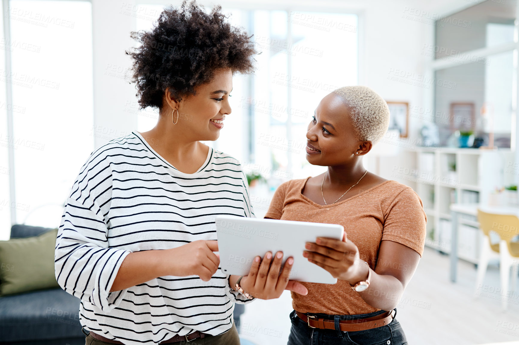 Buy stock photo Smile, tablet or women in startup meeting for online update, speaking or teamwork in conversation. People, technology or happy designers problem solving in office for planning, talking or solution