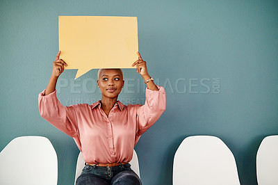 Buy stock photo Studio shot of an attractive young businesswoman looking thoughtful while holding up a speech bubble against a grey background