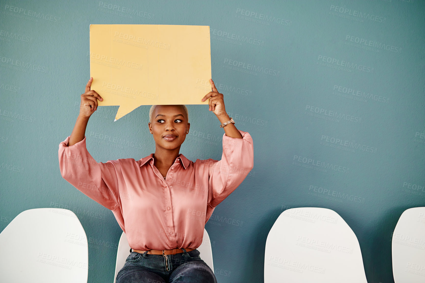 Buy stock photo Studio shot of an attractive young businesswoman looking thoughtful while holding up a speech bubble against a grey background