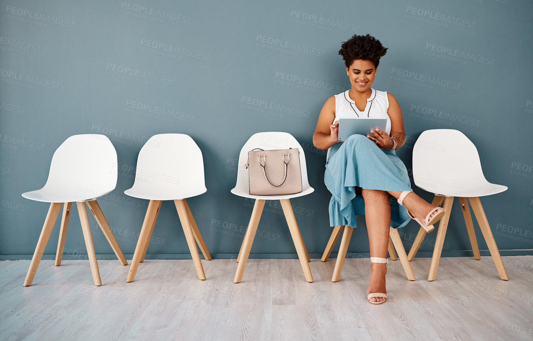 Buy stock photo Chairs, woman in waiting room and wall background, smile and tablet for appointment. Hiring, opportunity and recruitment in modern office workplace for interview, person and human resource candidate