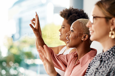 Buy stock photo Cropped shot of a group of attractive young businesswomen raising their hands to ask a question during a conference