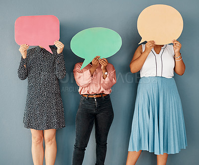 Buy stock photo Studio shot of a group of unrecognizable businesswomen covering their faces with speech bubbles while standing against a grey background