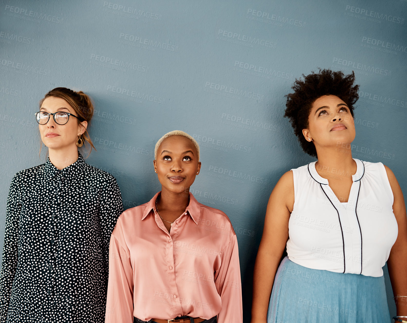 Buy stock photo Group, young women and thinking in studio for knowledge, education employees or looking up. Team, female teachers or blue background with contemplation at university, happiness or wellness in Morocco