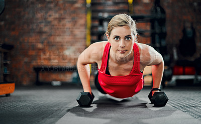 Buy stock photo Full length portrait of an attractive young female athlete working out with dumbbells in the gym