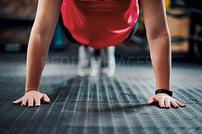 Buy stock photo Cropped shot of an unrecognizable young female athlete planking in the gym
