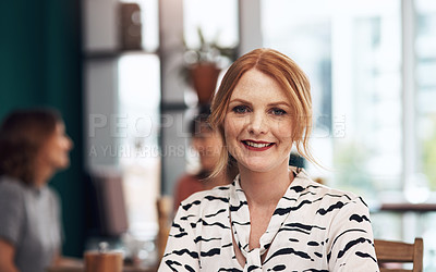 Buy stock photo Portrait of an attractive middle aged woman seated by herself inside of a coffee shop during the day