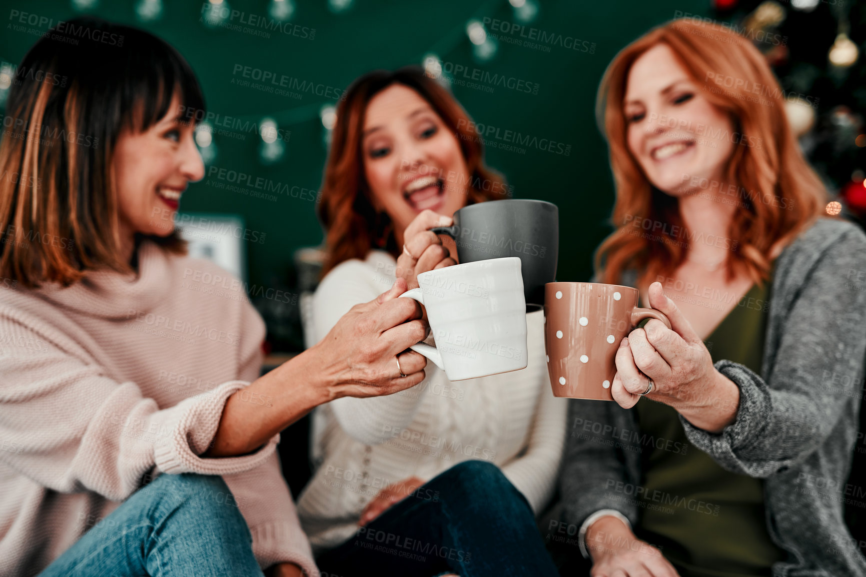 Buy stock photo Cropped shot of three attractive  middle aged women having coffee together during Christmas eve at home